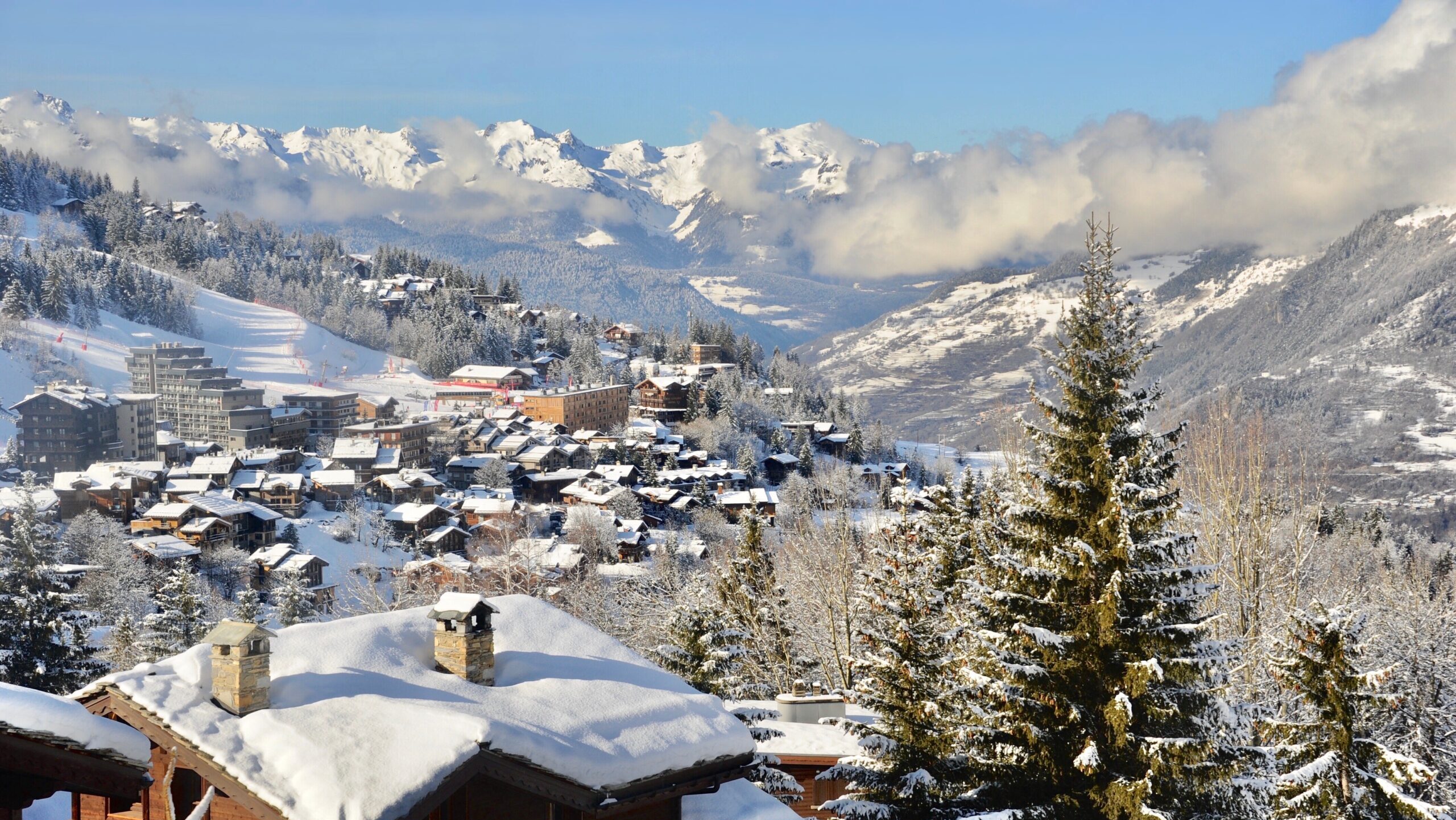 Courchevel 1550, Rhône Alps France, ski resort village in winter with wooden chalet and pine trees.