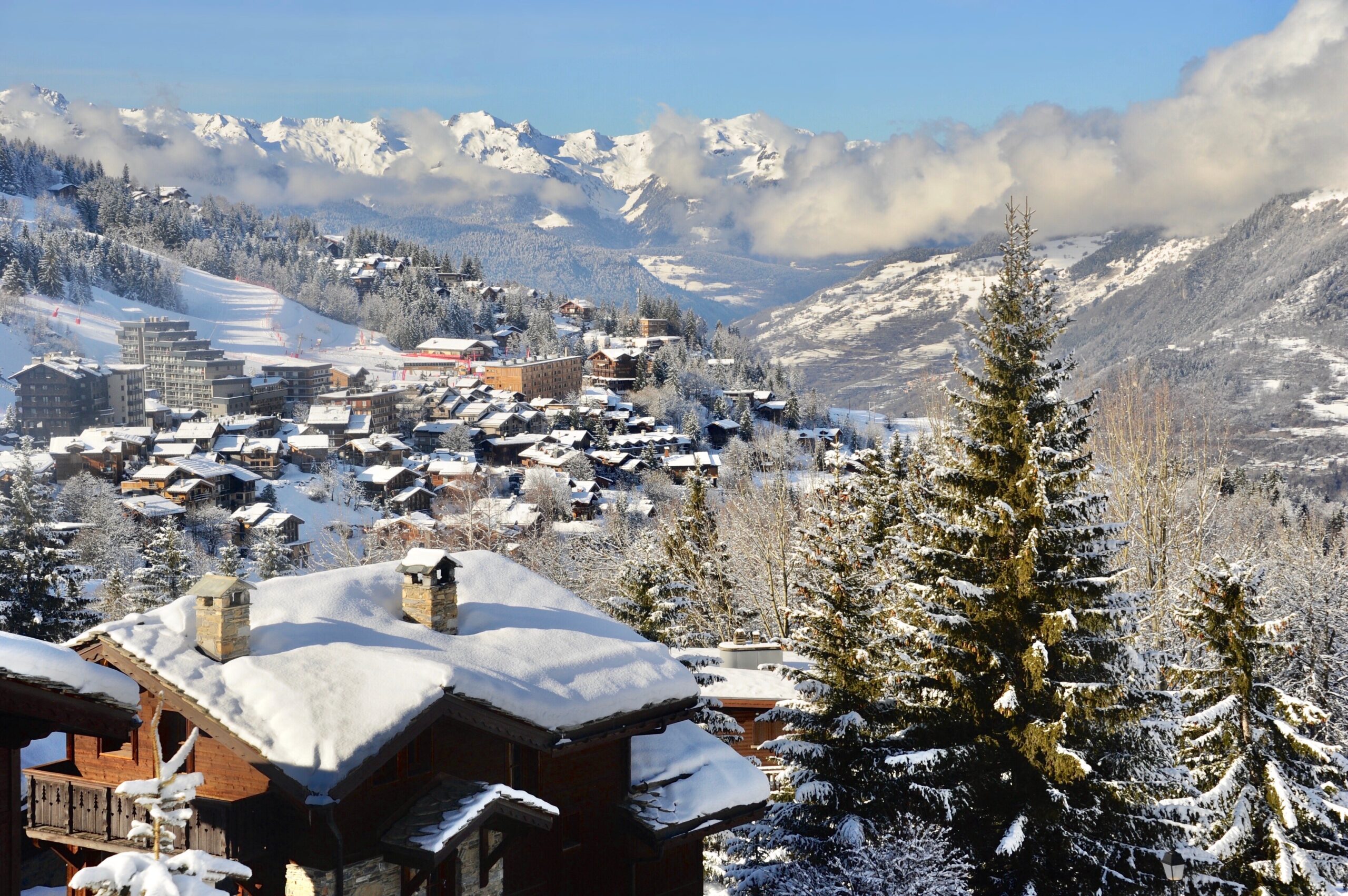 Courchevel 1550, Rhône Alps France, ski resort village in winter with wooden chalet and pine trees.